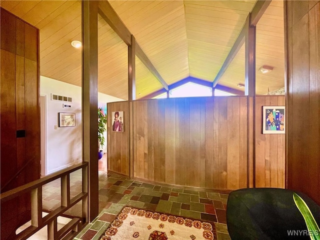 interior space featuring wooden walls and lofted ceiling