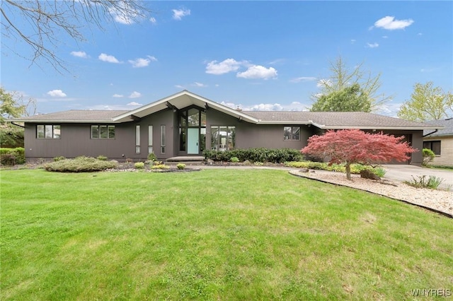 66 Stonecroft Ln, Amherst, NY 14226 - mid-century modern home featuring a front lawn, driveway, and a garage