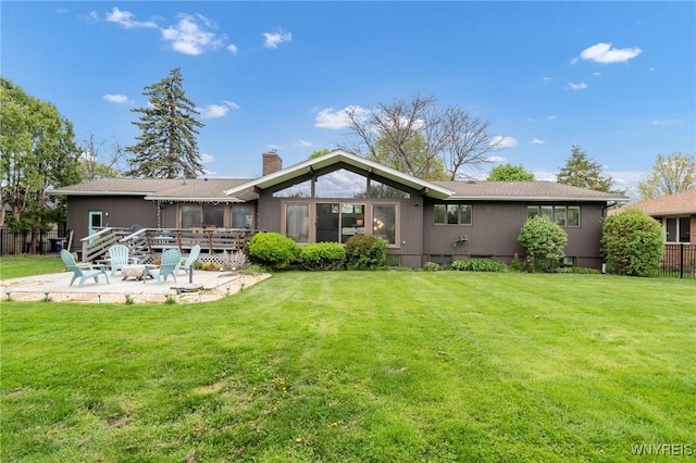 66 Stonecroft Ln, Amherst, NY 14226 - rear view of property with a patio area, a chimney, a wooden deck, and a fire pit
