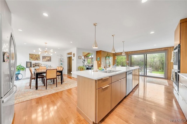 66 Stonecroft Ln, Amherst, NY 14226 - kitchen with appliances with stainless steel finishes, a sink, light wood-style floors, light countertops, and recessed lighting