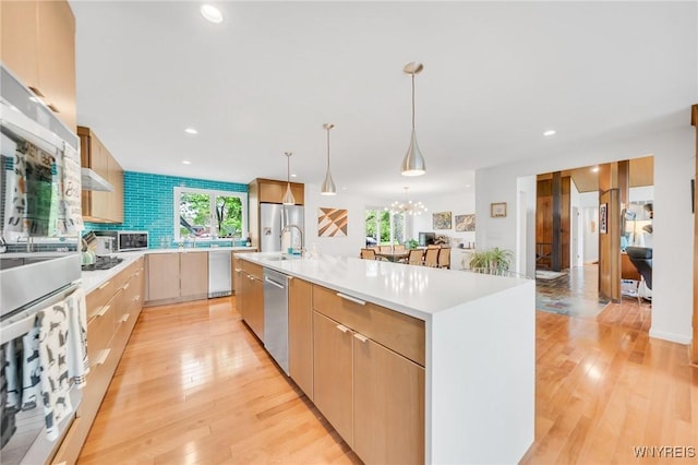 66 Stonecroft Ln, Amherst, NY 14226 - kitchen featuring light countertops, a chandelier, light wood-style flooring, backsplash, and recessed lighting