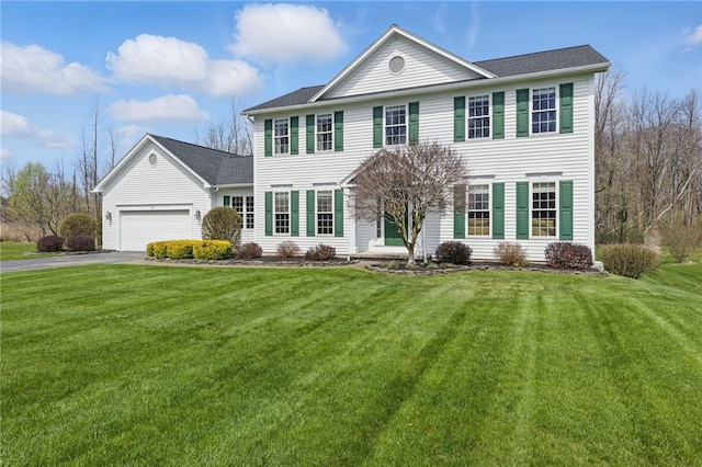 view of front of property featuring aphalt driveway, a front lawn, and a garage