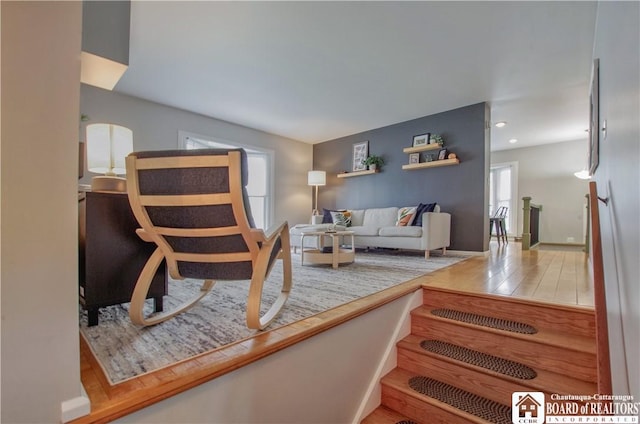 living area with recessed lighting and wood finished floors
