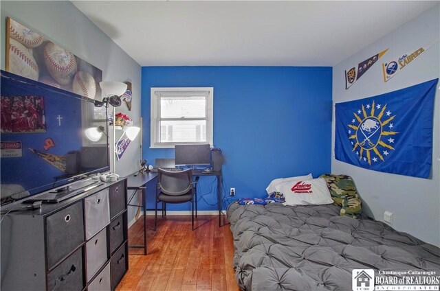 bedroom with hardwood / wood-style floors