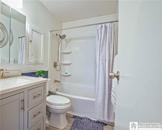 full bathroom featuring toilet, vanity, shower / bath combo with shower curtain, and wood finished floors