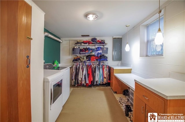 laundry room with washer and clothes dryer, electric panel, and cabinet space