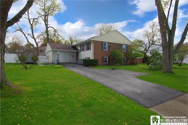 view of front facade featuring aphalt driveway, a front lawn, and brick siding