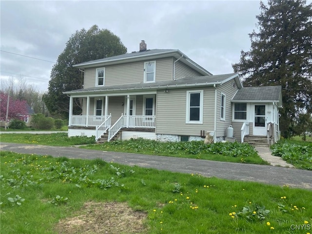 view of front of property with covered porch and a chimney