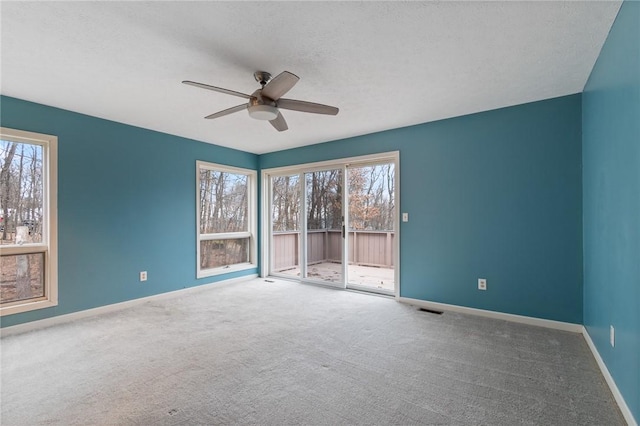 7893 Lake Rd, Sodus, NY 14555 - empty room with carpet flooring, visible vents, baseboards, and a ceiling fan