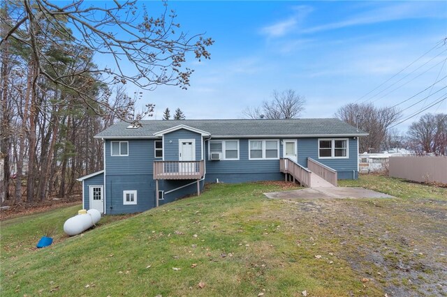 7893 Lake Rd, Sodus, NY 14555 - rear view of house featuring a shingled roof, a yard, and fence
