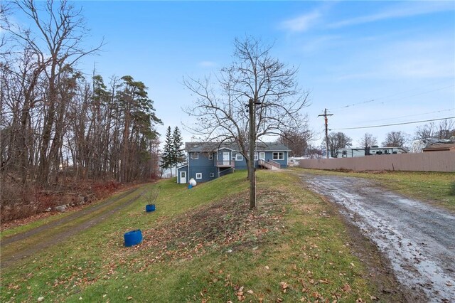 7893 Lake Rd, Sodus, NY 14555 - exterior space featuring fence, driveway, and a front yard