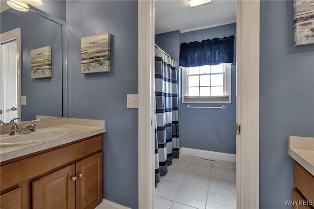 bathroom featuring baseboards, tile patterned flooring, vanity, and a shower with shower curtain