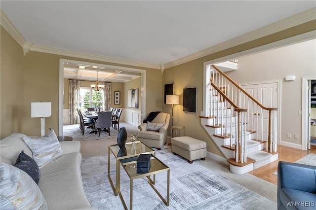 living area with ornamental molding, stairs, light carpet, and a chandelier