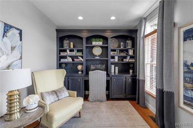 sitting room with wood finished floors and recessed lighting