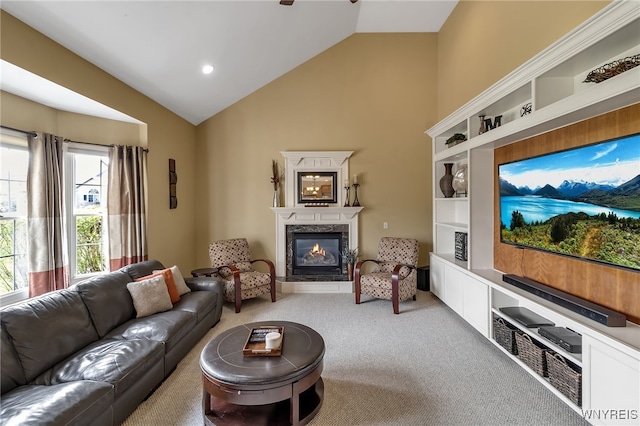 carpeted living room with lofted ceiling and a high end fireplace