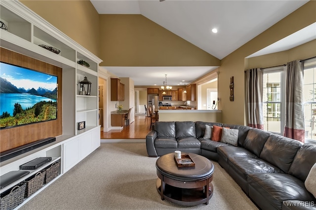 living room featuring recessed lighting, a notable chandelier, high vaulted ceiling, and light colored carpet