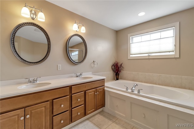 bathroom featuring a sink, double vanity, a garden tub, and tile patterned floors