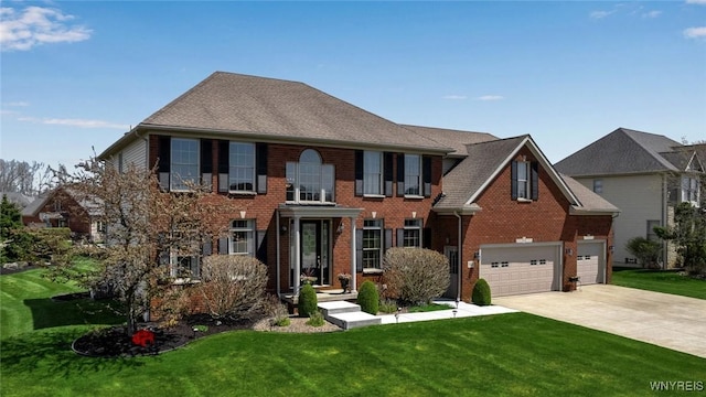view of front facade featuring concrete driveway, a front yard, brick siding, and a garage