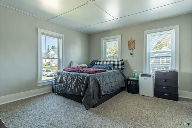 carpeted bedroom featuring baseboards