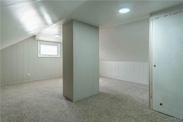 bonus room featuring vaulted ceiling and carpet flooring
