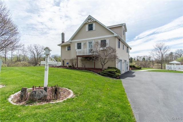 21770 Bullhead Bay Rd, Alexandria, NY 13640 - view of front of home featuring an attached garage, a chimney, driveway, and a front lawn