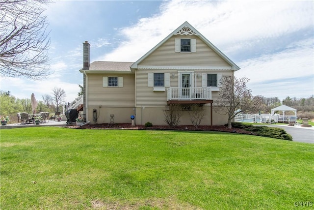 21770 Bullhead Bay Rd, Alexandria, NY 13640 - view of front of property featuring a chimney, a front lawn, a patio, and a gazebo