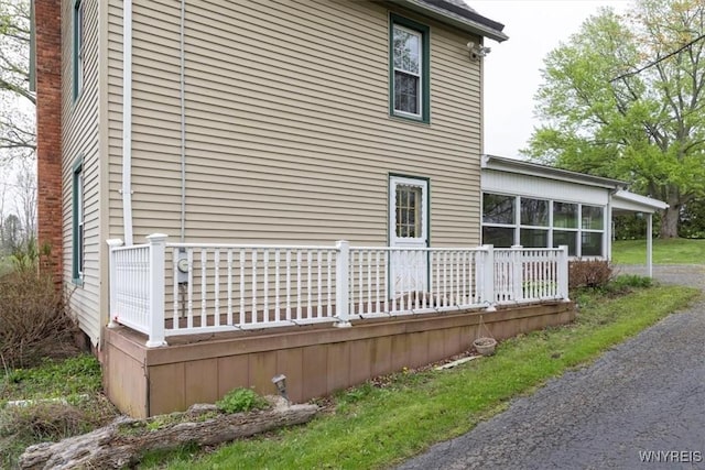 view of property exterior featuring a sunroom