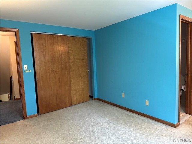 unfurnished bedroom featuring baseboards, a closet, and carpet floors