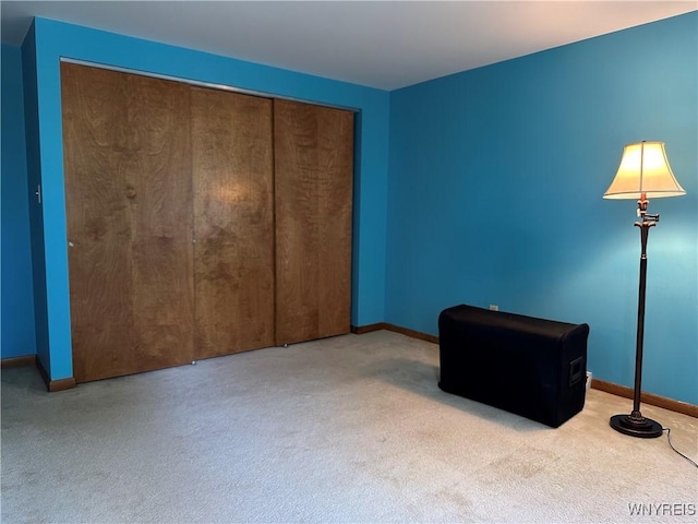 unfurnished bedroom with baseboards, a closet, and carpet