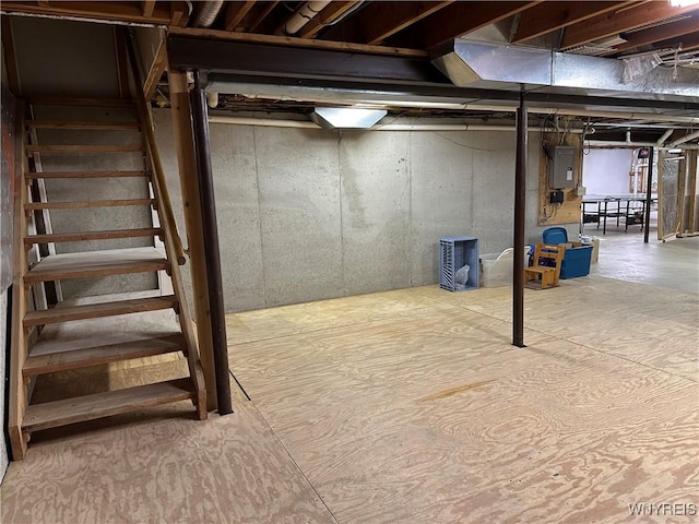 unfinished below grade area with electric panel and stairs