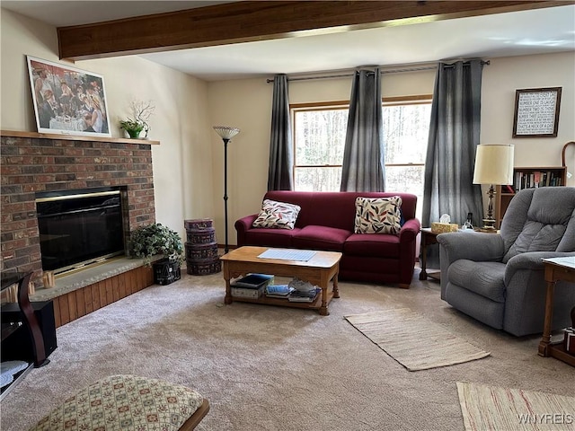 living area featuring carpet, beamed ceiling, and a brick fireplace