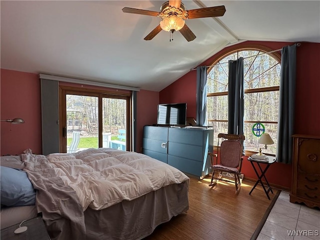 bedroom featuring ceiling fan, lofted ceiling, access to outside, and multiple windows