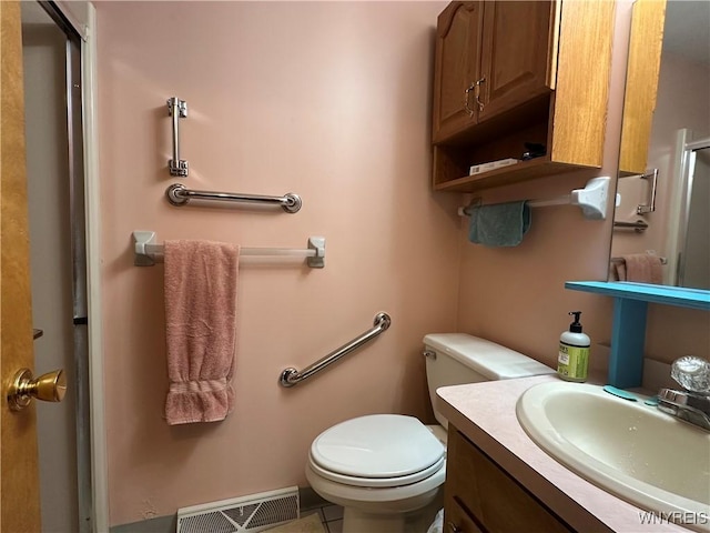bathroom with vanity, toilet, visible vents, and tile patterned flooring