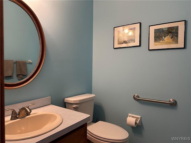 half bathroom with toilet and vanity
