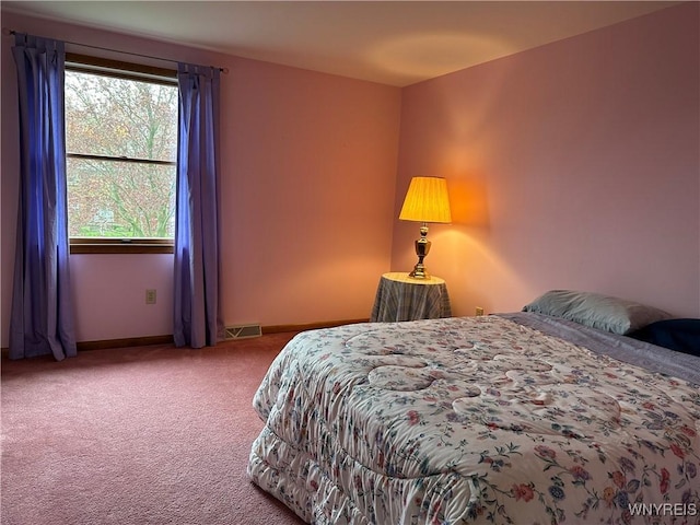 carpeted bedroom with baseboards and visible vents
