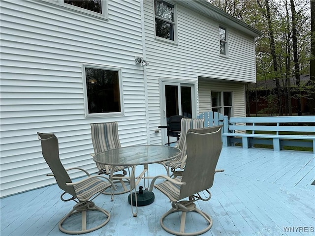 wooden terrace with outdoor dining area