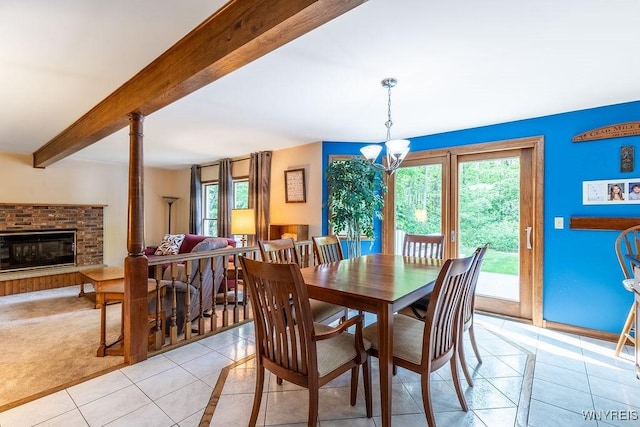 103 Old Orchard Ln, Orchard Park, NY 14127 - dining area featuring light tile patterned floors, beamed ceiling, a chandelier, and a fireplace