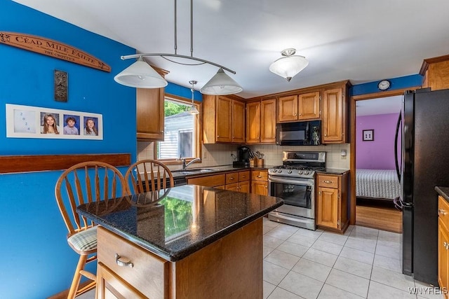 103 Old Orchard Ln, Orchard Park, NY 14127 - kitchen featuring black appliances, backsplash, brown cabinetry, light tile patterned floors, and a sink