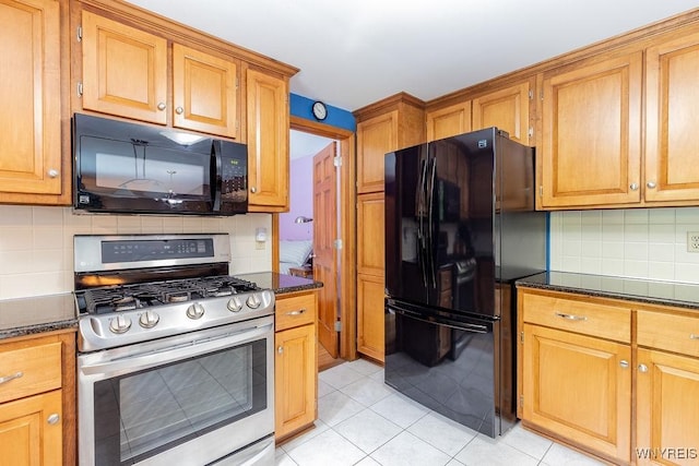 103 Old Orchard Ln, Orchard Park, NY 14127 - kitchen with black appliances, backsplash, light tile patterned floors, dark stone counters, and brown cabinetry