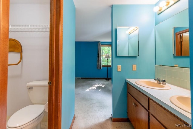 103 Old Orchard Ln, Orchard Park, NY 14127 - bathroom with double vanity, toilet, tasteful backsplash, and baseboards