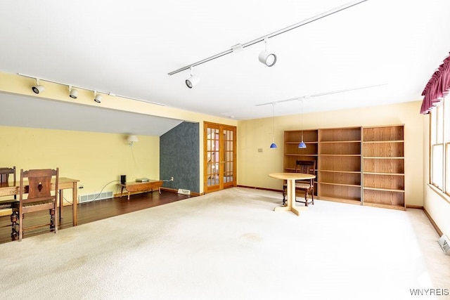 103 Old Orchard Ln, Orchard Park, NY 14127 - below grade area with track lighting, french doors, carpet flooring, and baseboards