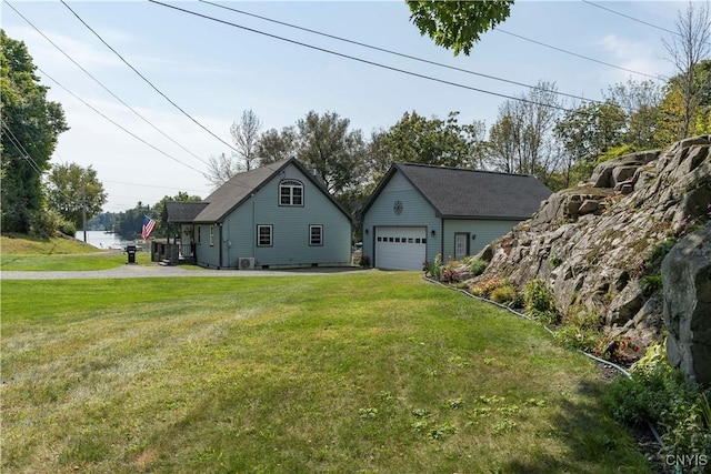 44458 County Route 100, Alexandria, NY 13640 - view of side of property with a detached garage, an outbuilding, and a lawn