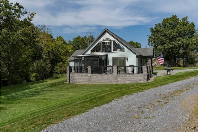44458 County Route 100, Alexandria, NY 13640 - back of property featuring a sunroom, a shingled roof, and a yard