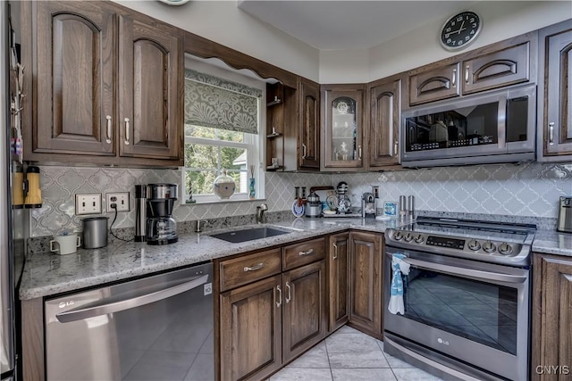 44458 County Route 100, Alexandria, NY 13640 - kitchen with light stone countertops, tasteful backsplash, appliances with stainless steel finishes, and a sink