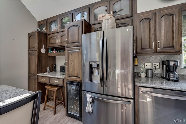 44458 County Route 100, Alexandria, NY 13640 - kitchen with stainless steel appliances, wine cooler, backsplash, glass insert cabinets, and dark brown cabinets