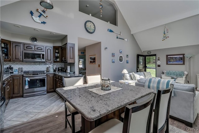44458 County Route 100, Alexandria, NY 13640 - dining space with light wood-style flooring and high vaulted ceiling