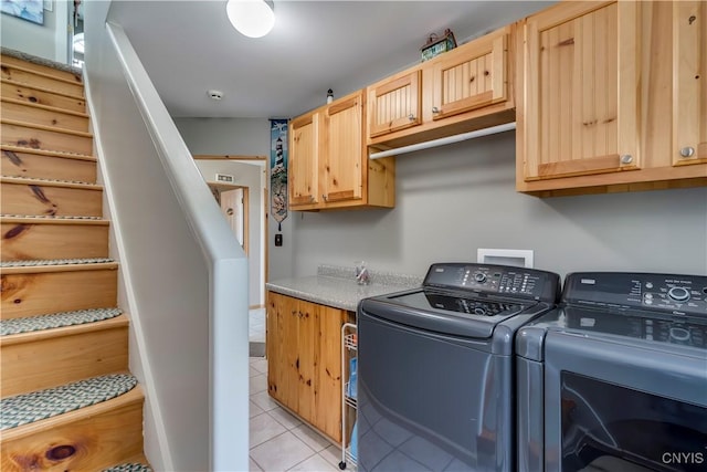44458 County Route 100, Alexandria, NY 13640 - clothes washing area featuring washing machine and dryer, light tile patterned flooring, and cabinet space