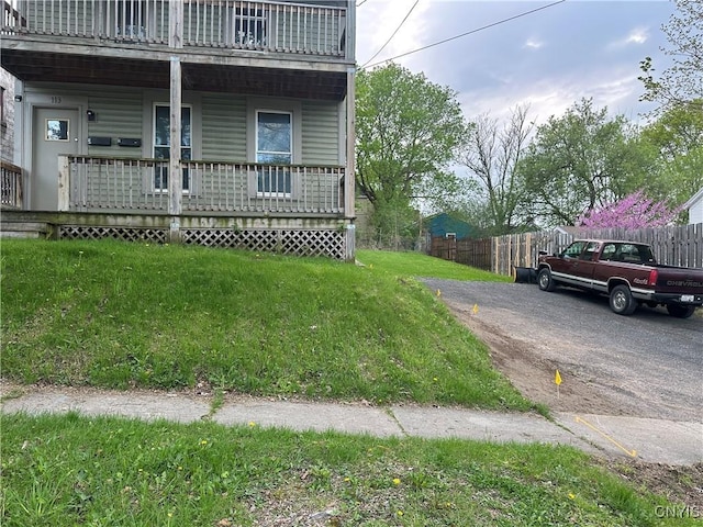 113 Grumbach Ave, Syracuse, NY 13203 - view of side of home featuring a porch, fence, a lawn, and a balcony