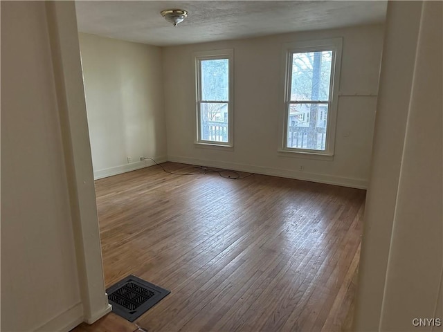 113 Grumbach Ave, Syracuse, NY 13203 - spare room with baseboards, hardwood / wood-style floors, and visible vents