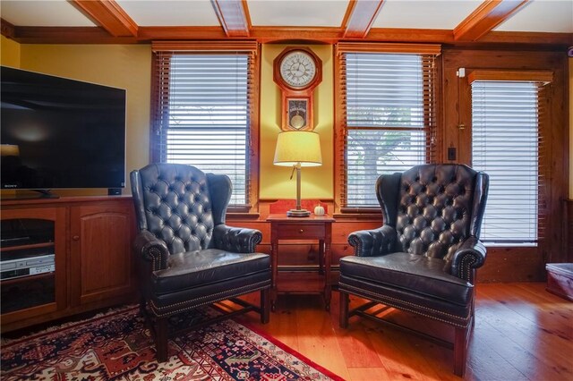 sitting room with coffered ceiling, beamed ceiling, and hardwood / wood-style floors